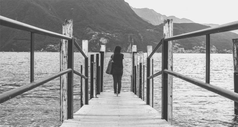 Woman stands at the end of a dock