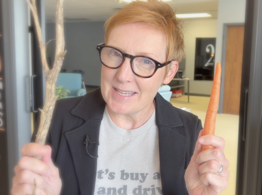 Jackie Pelland holding a carrot and a stick