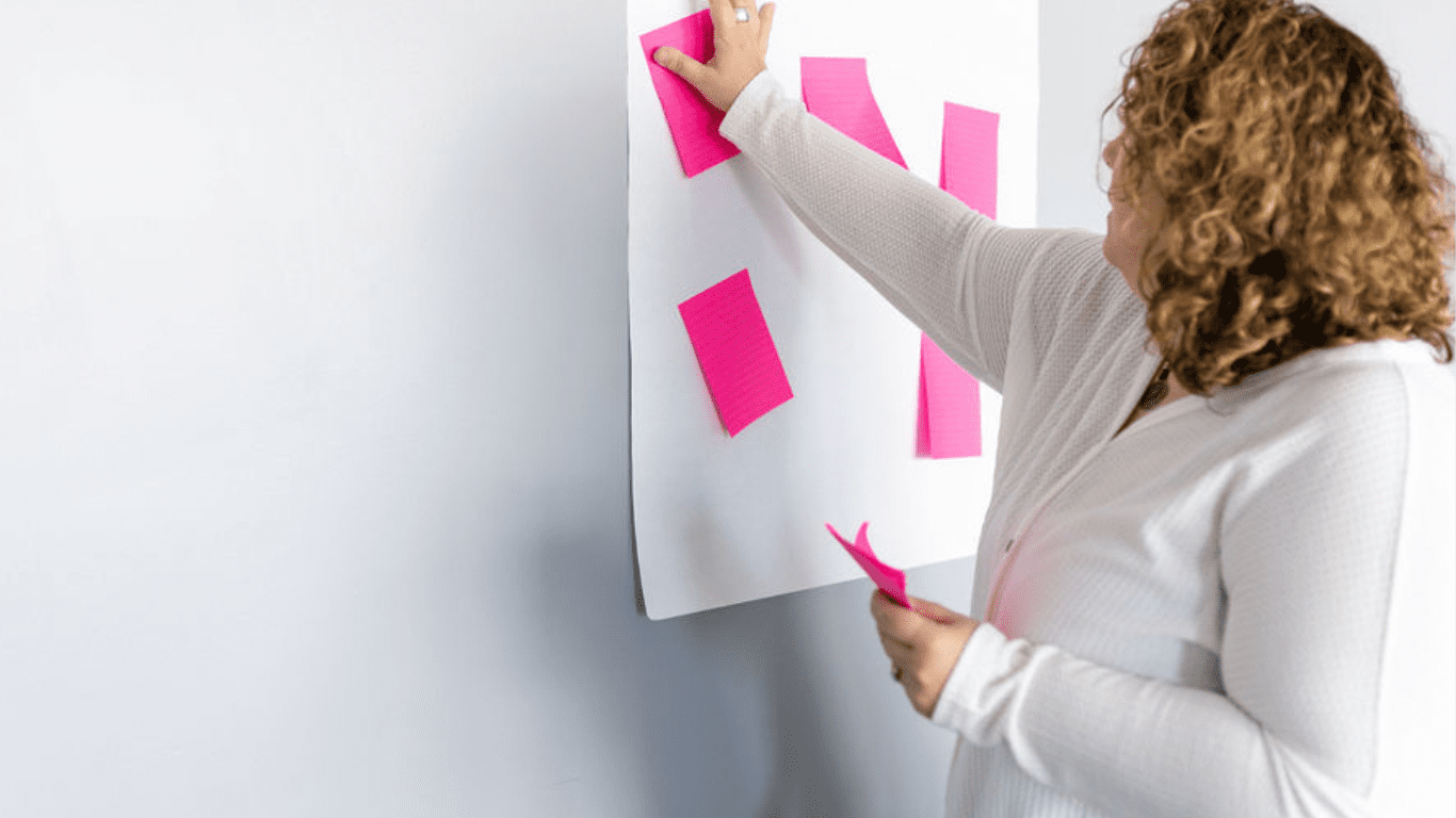 courtney with post-its courtney putting pick post it notes on a white board